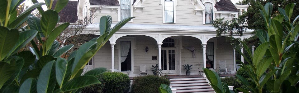 The Watkins-Cartan House in Atherton, a white Victorian with a deep covered porch