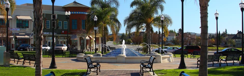 Evergreen Village Square in San Jose, with a fountain and palm trees