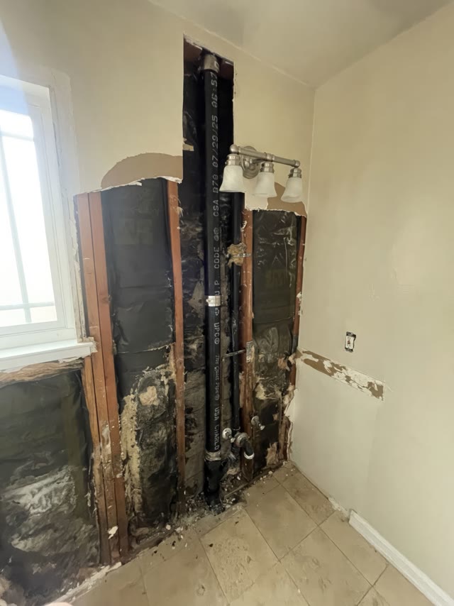 Interior wall opened to expose water damage