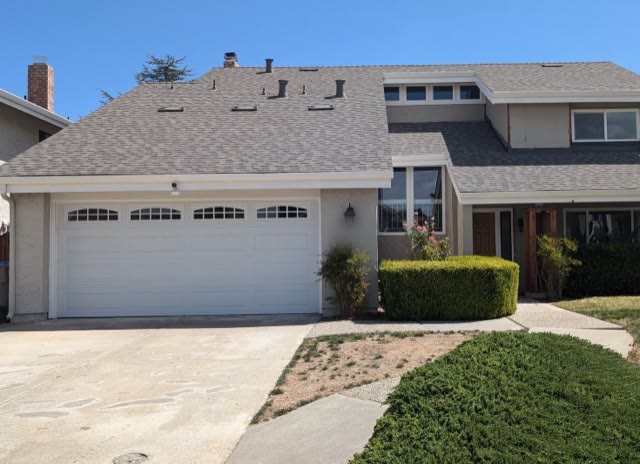The same house from the same spot in the driveway, finished with a new grey composition shingle roof
